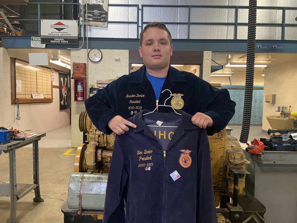 Brandon Derico wearing FFA jacket and holding his father's jacket